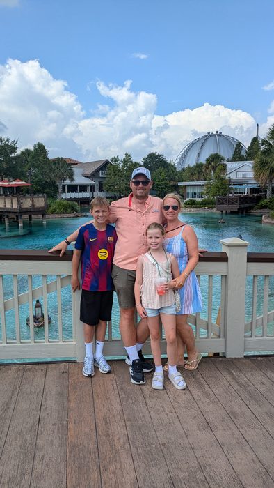 Andreas with his wife, Jayden and Olivia on a bridge over blue water in Florida